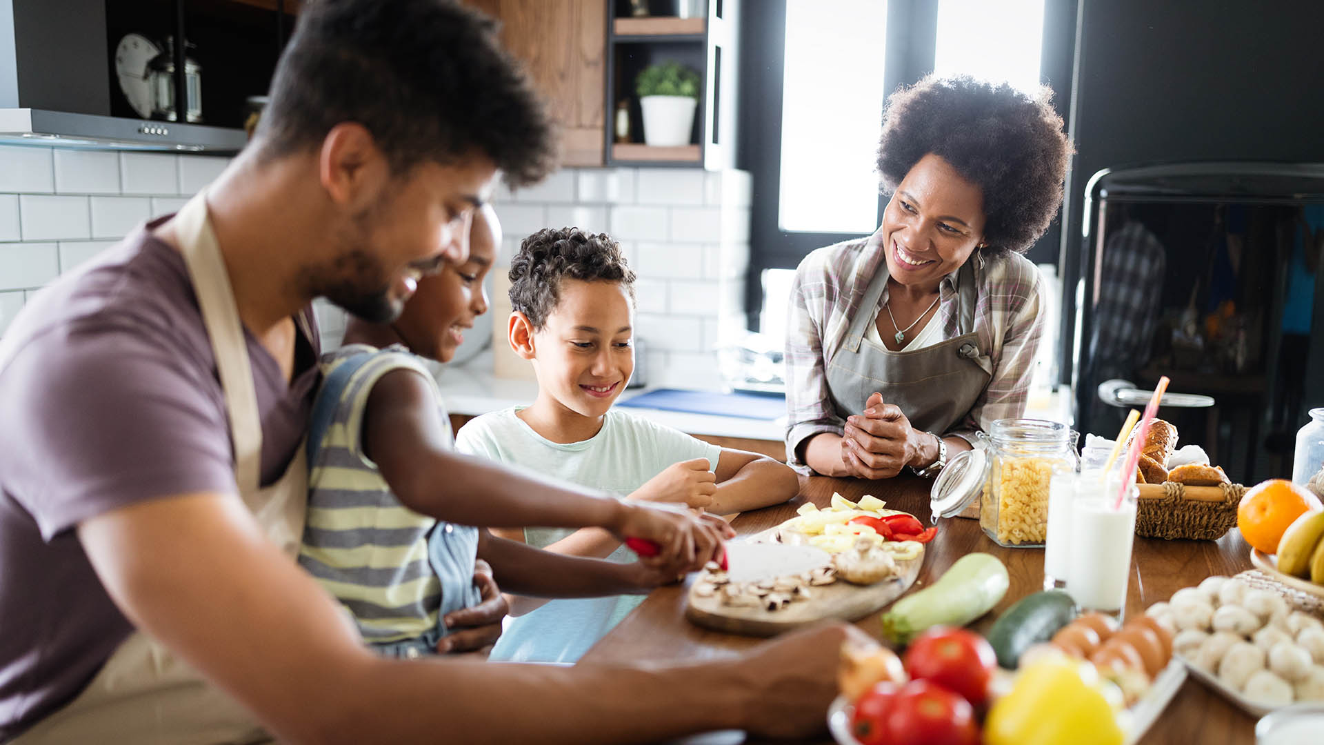 Happy Family In The Kitchen Having Fun And Cooking Together