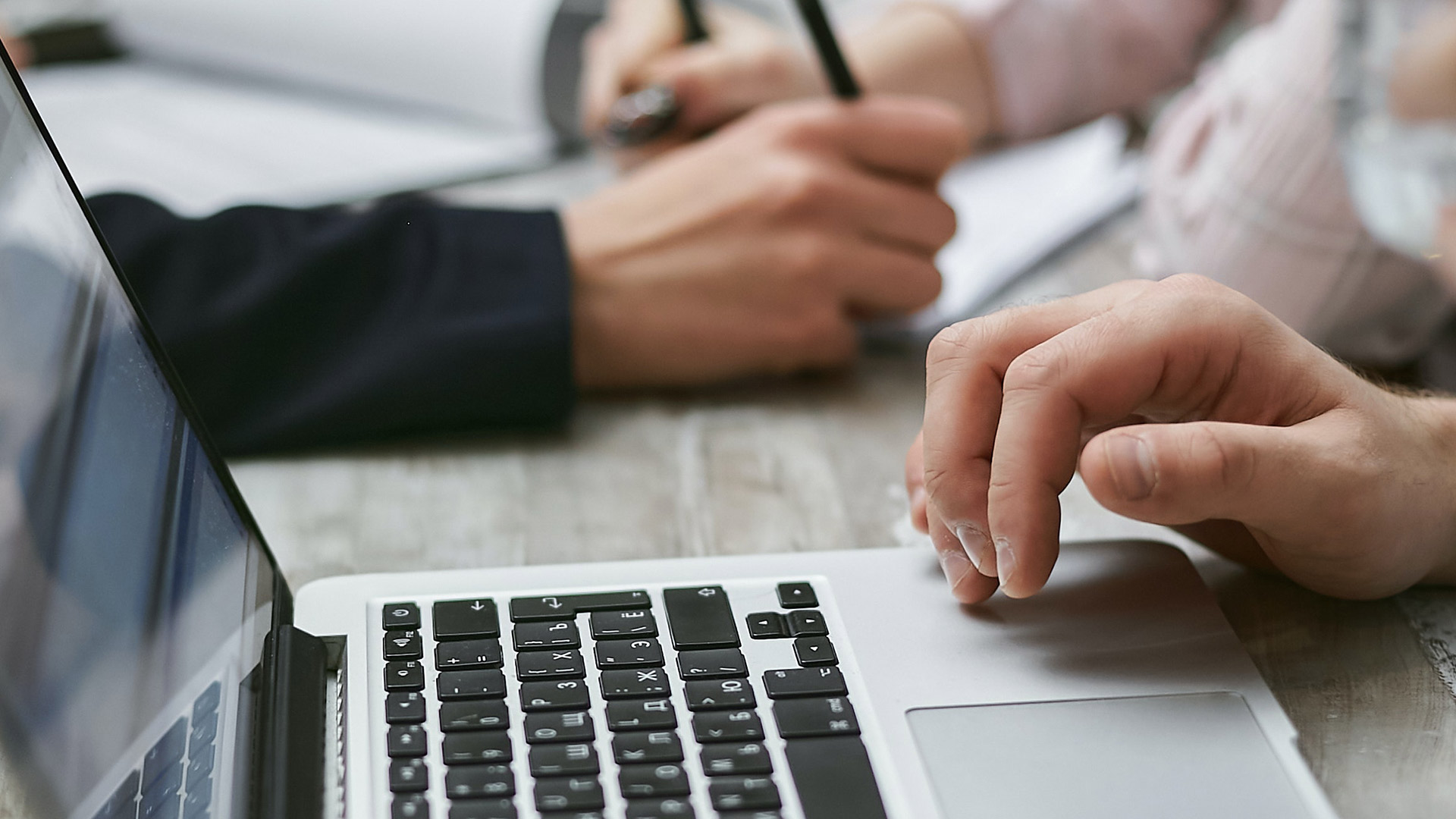 hands of colleague on desk